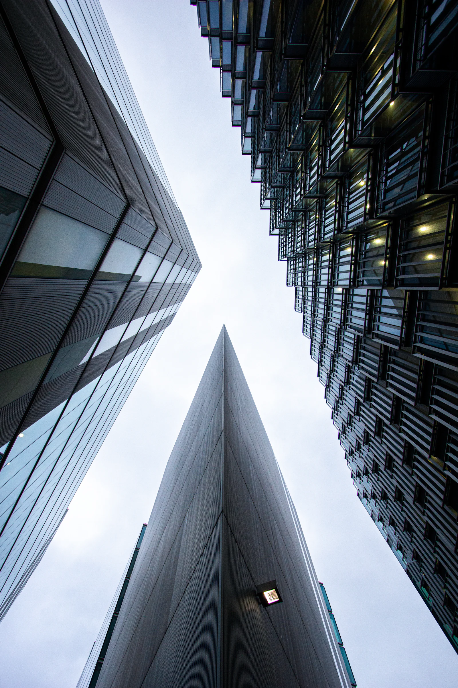 Glass towers rising into a pale sky
