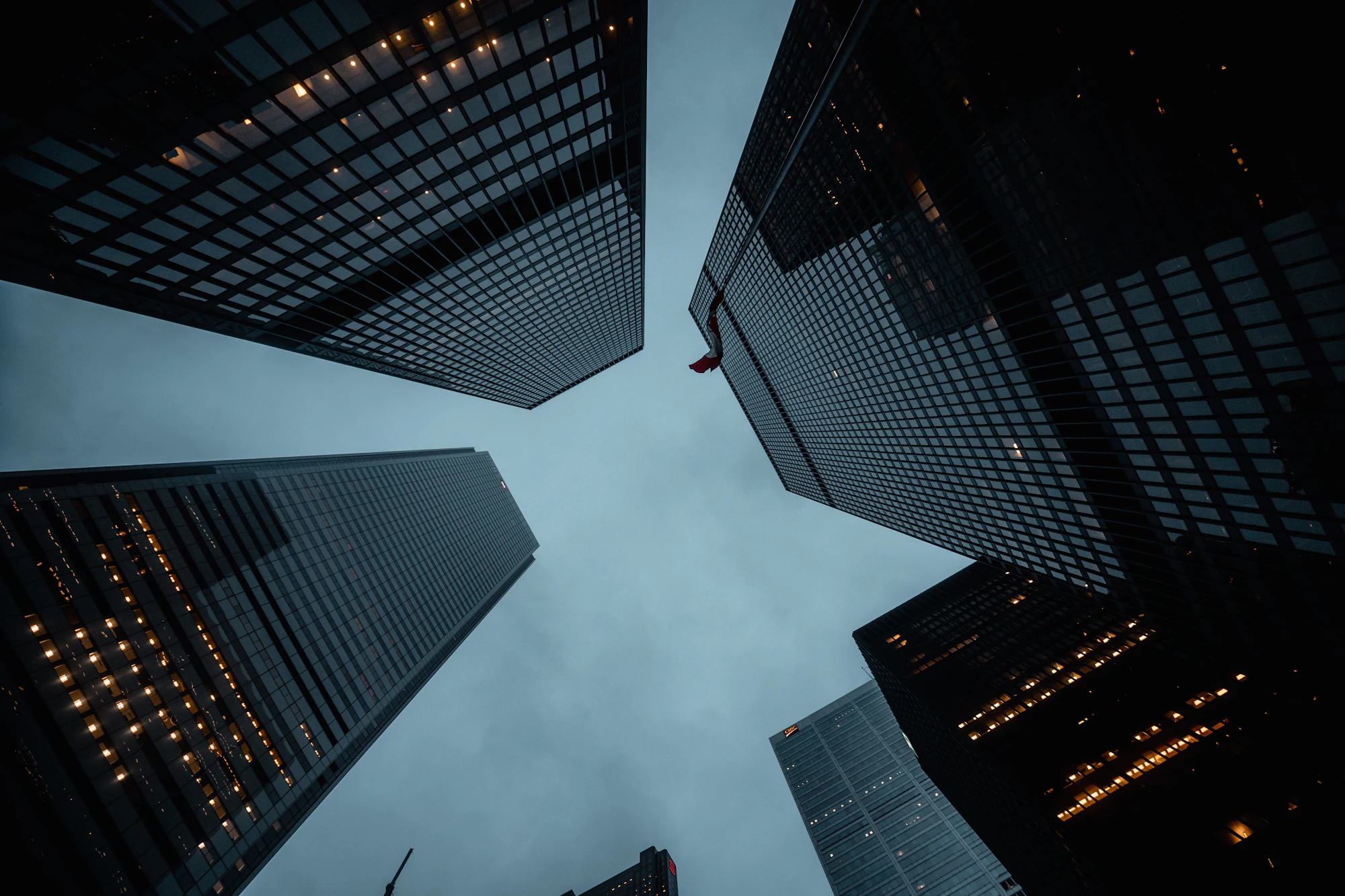 Looking up at glass skyscrapers at dusk